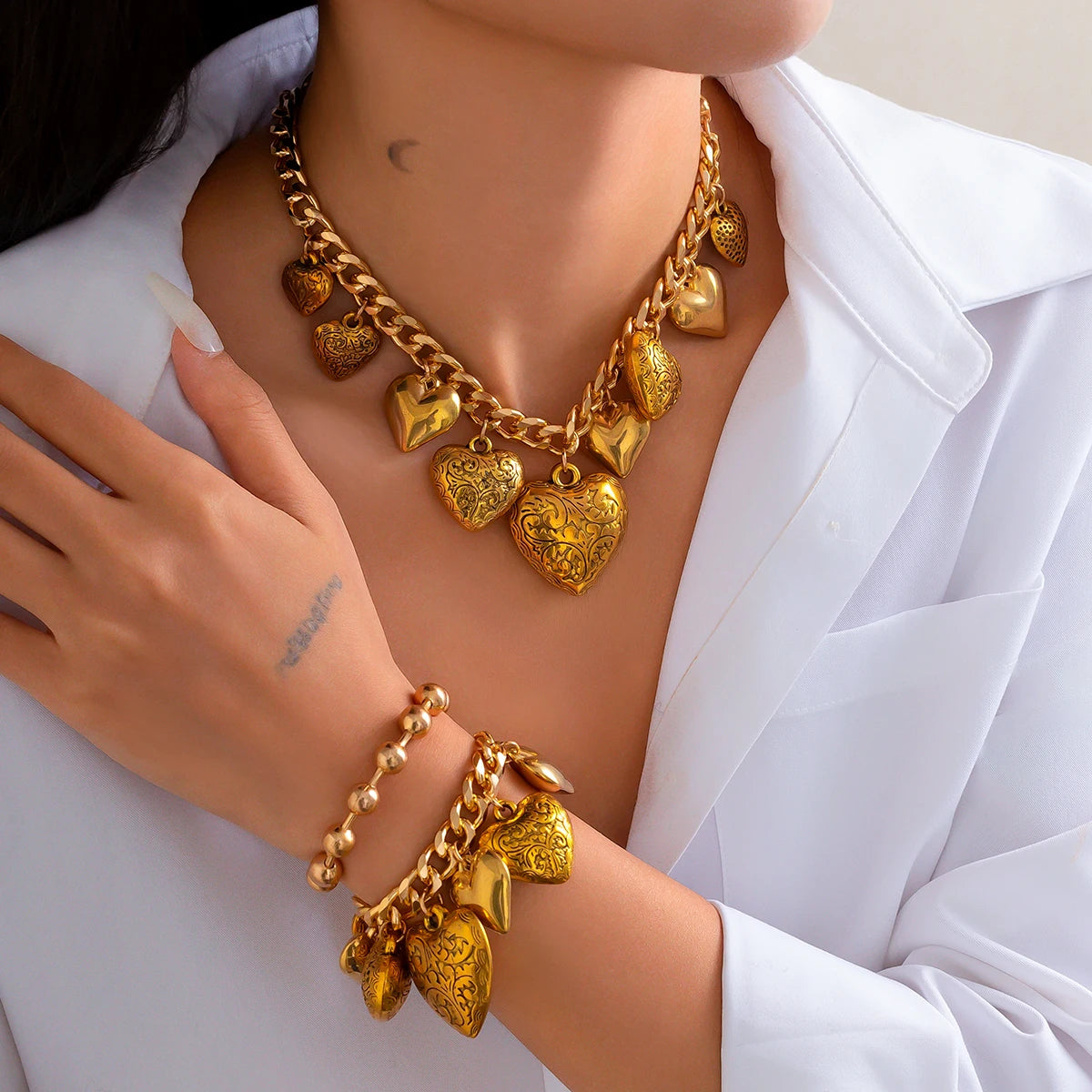 Heart necklace and bracelet set in gold tone