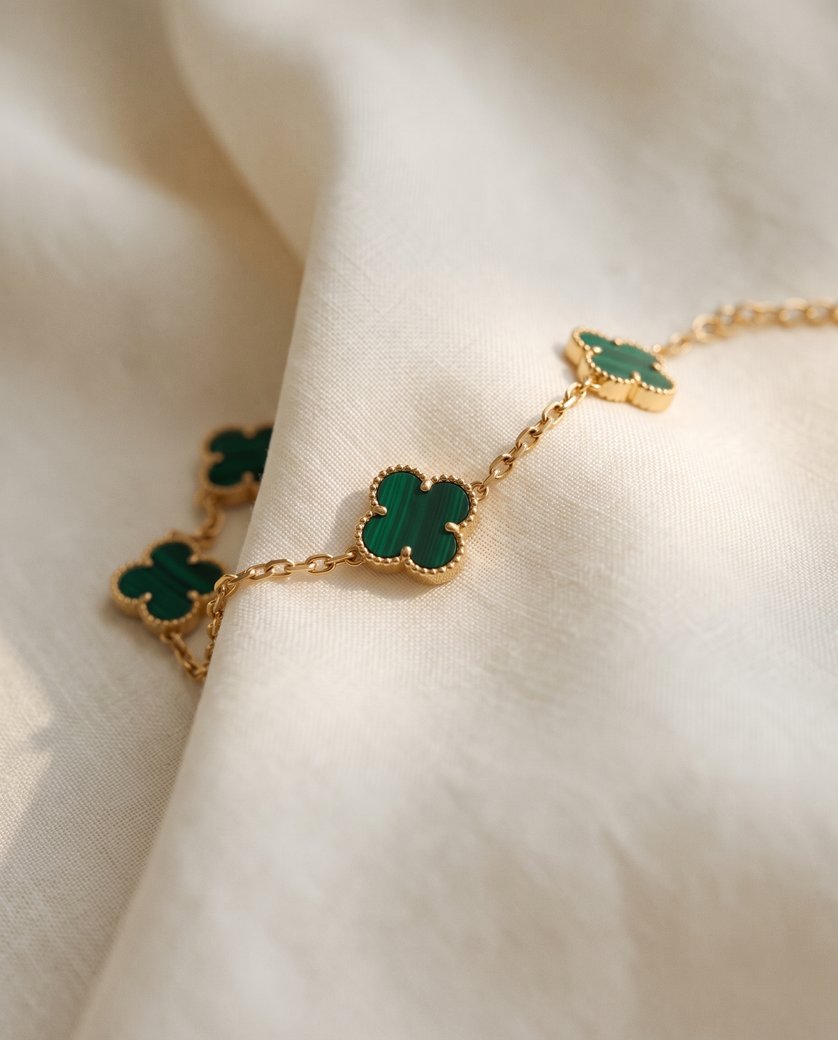 The Clover Bracelet in green on ivory linen