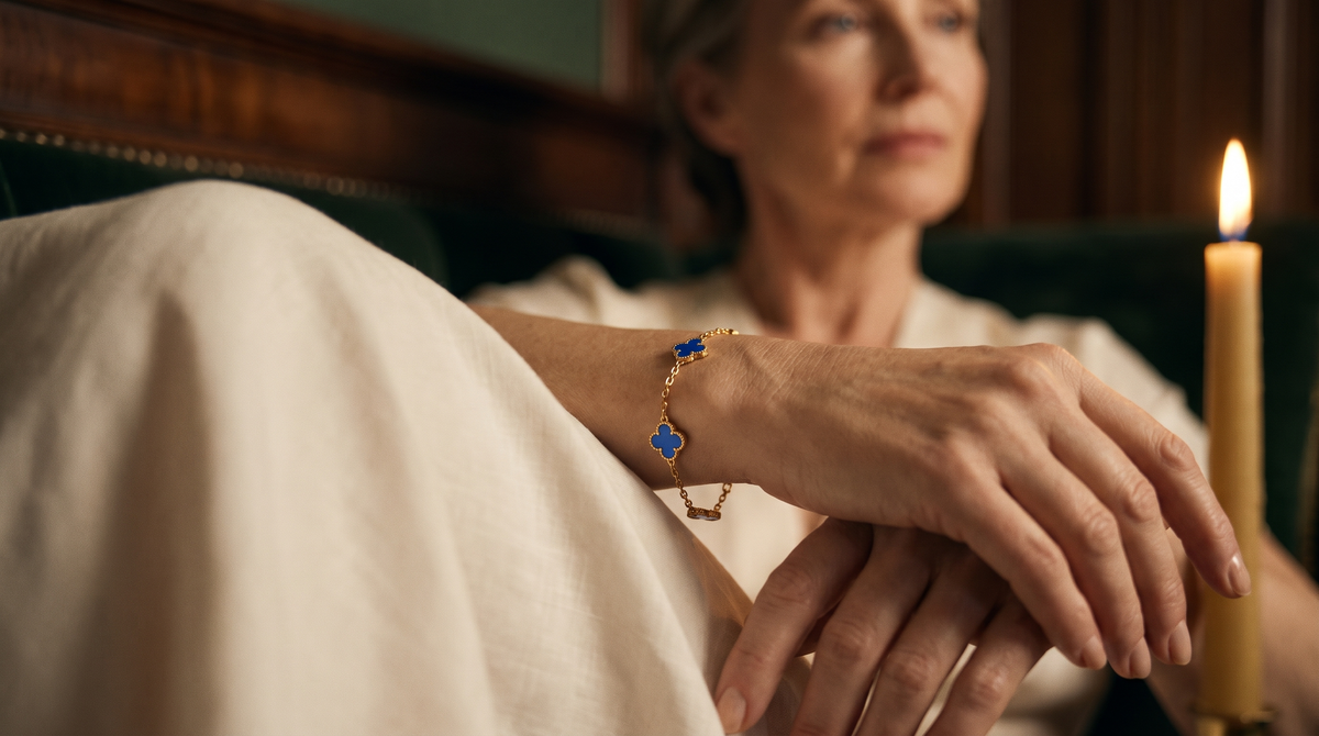 Blue clover bracelet worn on the wrist by candlelight