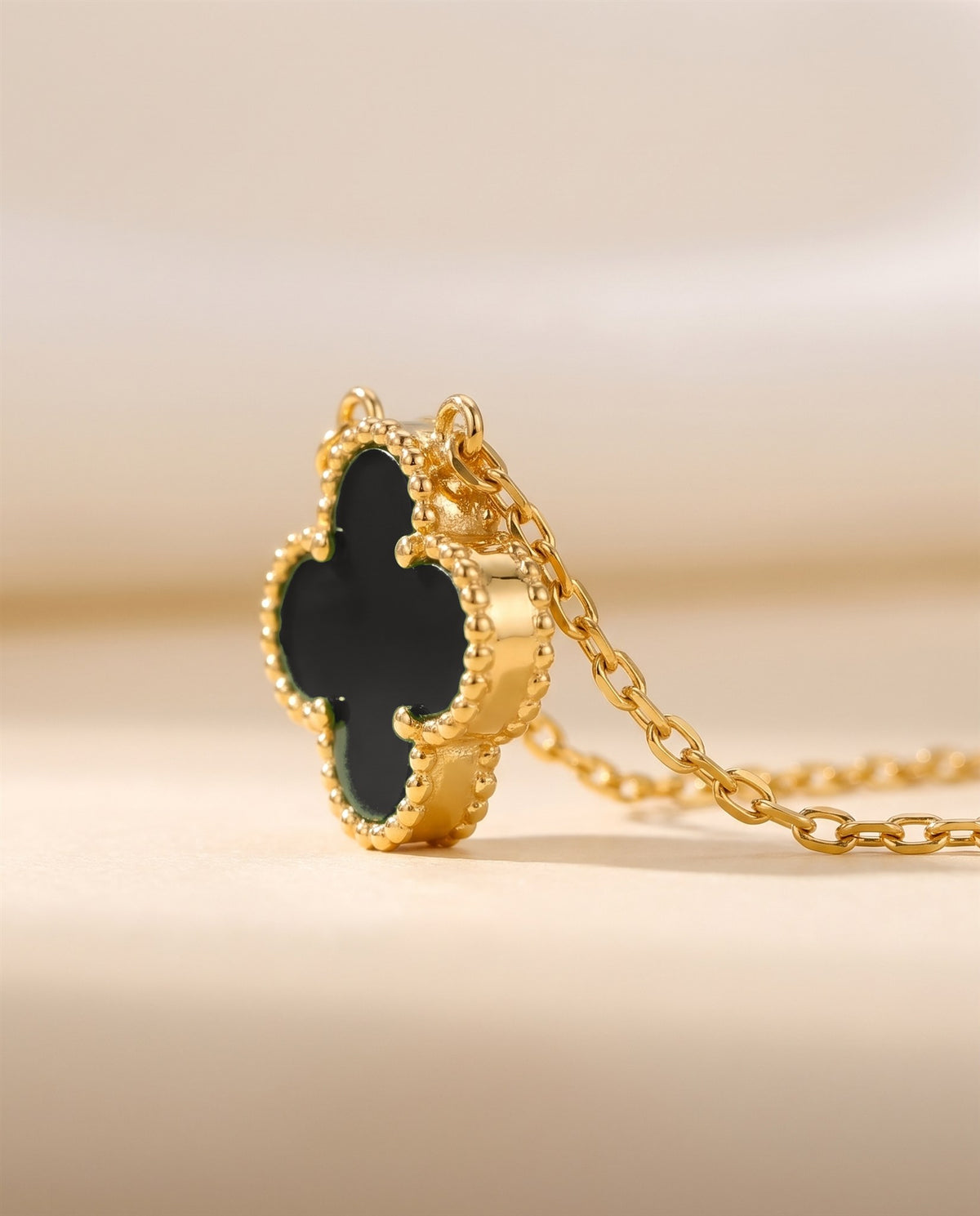 The Clover Necklace in black, close view of the pendant